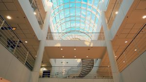 a large atrium with a spiral staircase and a skylight