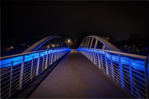 a bridge that is lit up with blue lights