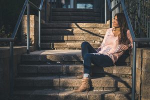 woman sitting on stairs outdoor